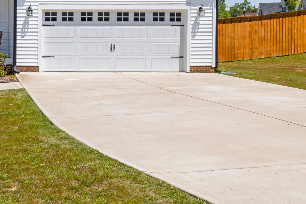New concrete driveway in front of a garage