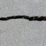 Crack in an exposed aggregate concrete driveway